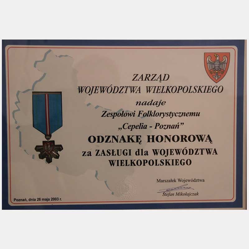 Na zdjęciu dyplom z napisem nagroda za zasługi dla województwa= wielkopolskiego